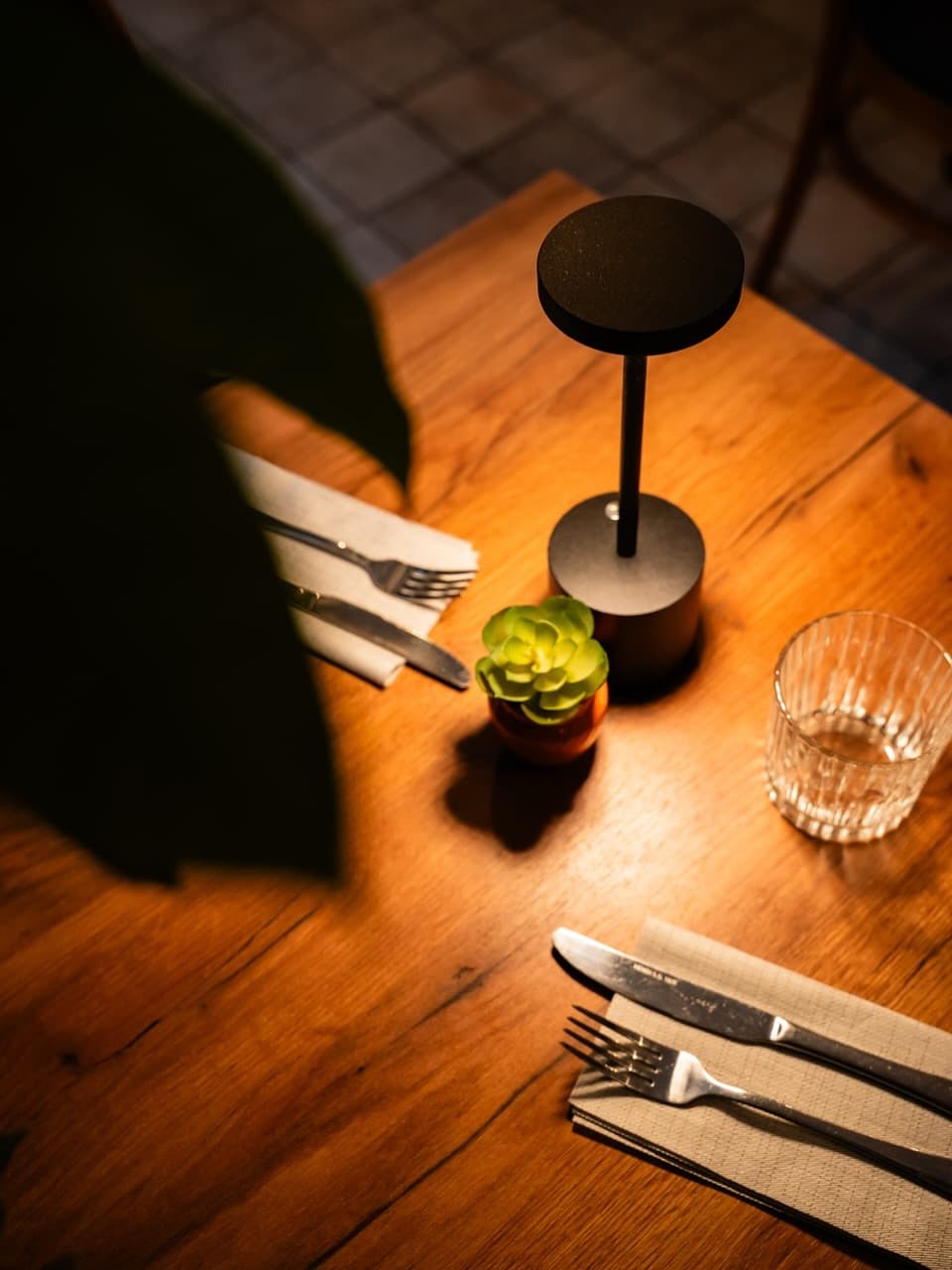 A candlelit table setting at AAYAM