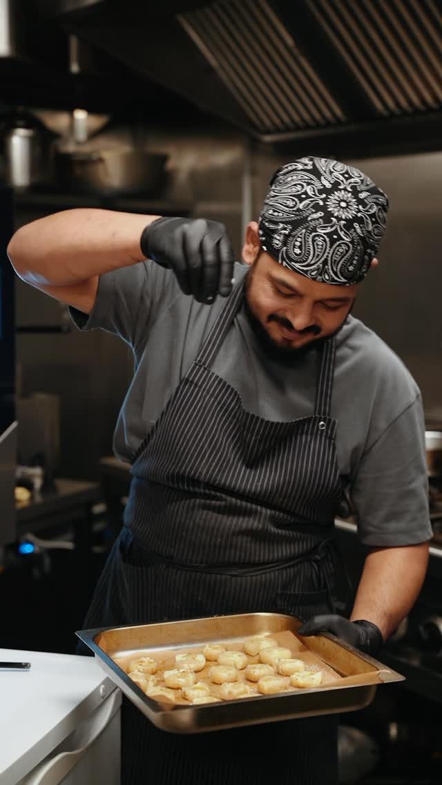 action shot of chef garnishing dish